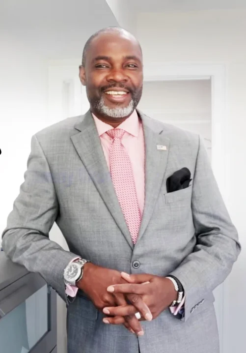 Professional portrait of a licensed agent from DMV real estate experts team in a gray suit and pink tie